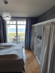 a bedroom with a bed and a view of the ocean at Maisonettewohnung Strandburg in Lubmin