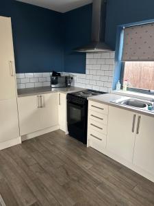 a kitchen with white cabinets and a black stove top oven at Spitfire in Boston