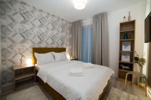 a bedroom with a large white bed in a room at Carpe Diem Travel in Timişoara