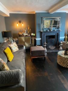 a living room with a couch and a fireplace at B&Bat no3 in Market Bosworth