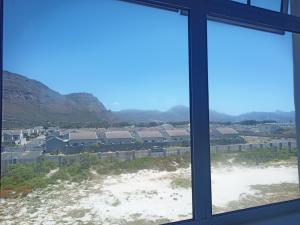 a window with a view of a city at Dune Crest - 2 Bedroom Apartment in Cape Town