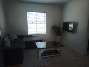 a living room with a couch and a coffee table at Dune Crest - 2 Bedroom Apartment in Cape Town