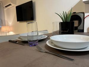 stół z płytkami i szklanką wody w obiekcie Chez Julien & Ornella w mieście Saint-Laurent-du-Var