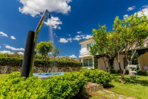 a house with a garden with a giant shovel at The Pelican Beach Resort & SPA - Adults Only in Olbia