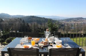 a blue table with a plate of food on it at Quinta Milhão - Casa do Pomar in Guimarães