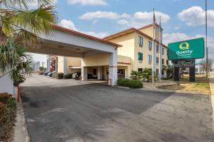 a hotel building with a sign in front of it at Quality Inn & Suites Ft Jackson Maingate in Columbia