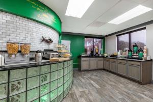 a large kitchen with green walls and a counter at Quality Inn & Suites Ft Jackson Maingate in Columbia