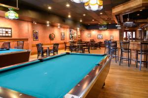 a pool table in a bar with tables and chairs at Quality Inn in Lewisburg