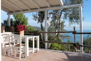 a porch with a table and chairs and a view of the water at Gli Orizzonti di Agata in Mattinata