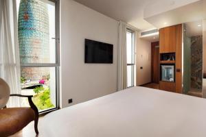 a bedroom with a bed and a large window at Hotel SB Glow Sup in Barcelona