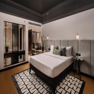 a bedroom with a large white bed in a room at The Raintree, St. Mary’s Road in Chennai
