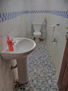 a bathroom with a sink and a toilet at Zuri Stays Machakos Town in Machakos