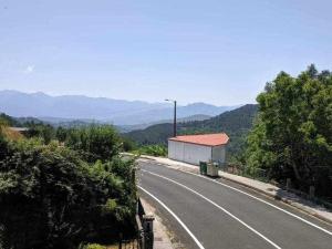 a road with a building on the side of it at Casa Ourense Guxinde in Pereira