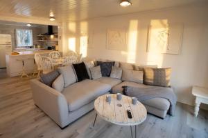 a living room with a couch and a table at Stunning lodge on the lake in South Cerney