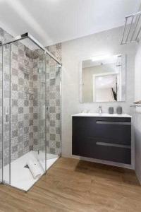 a bathroom with a glass shower and a sink at Sunny Island Lago Martianez 4 in Puerto de la Cruz