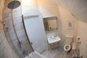 a bathroom with a shower and a toilet and a sink at Barefoot lodge in South Cerney +12 photos