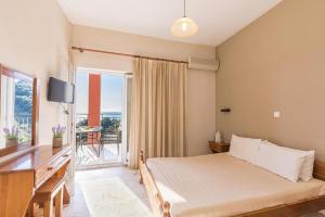 A bed or beds in a room at Pool Apartments with panoramic sea view - Pelekas Beach, Corfu