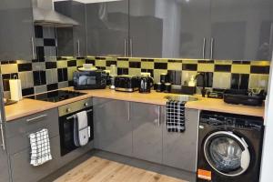 a kitchen with a sink and a washing machine at Modern One-bedroom flat in Maidstone in Maidstone