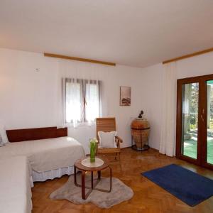 a bedroom with a bed and a table and a chair at Beach House Wild Paradise in Silba