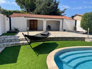 una hamaca en un patio junto a una piscina en Holiday Home in Pouzols-Minervois with Private Outdoor Pool, en Pouzols-Minervois