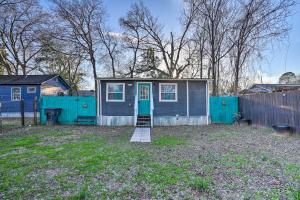 a small house with a blue door in a yard at Shreveport Vacation Rental Near Riverfront in Shreveport