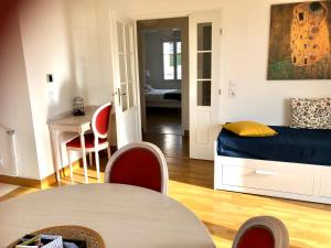 a bedroom with a bed and a table and chairs at Villa Médicis Trouville-sur-mer in Trouville-sur-Mer