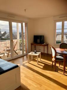a living room with a table and a dining room at Villa Médicis Trouville-sur-mer in Trouville-sur-Mer