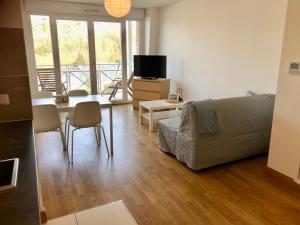 a living room with a couch and a table at Villa Médicis Trouville-sur-mer in Trouville-sur-Mer