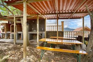 una mesa de picnic y un banco bajo una pérgola en Carmelo y Carmela 4, en Teror