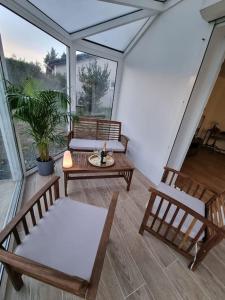 una veranda schermata con 2 sedie e un tavolo di Maison Chaleureuse a Villepinte