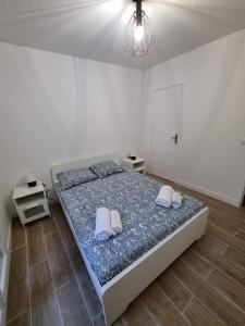 a bedroom with a large bed with two pillows on it at Maison Chaleureuse in Villepinte