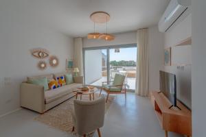 a living room with a couch and a tv at VESTA - El Gouna Residence in Hurghada