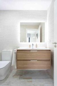 a bathroom with a sink and a toilet and a mirror at Sunny Island Villa Sueño Azul in Callao Salvaje