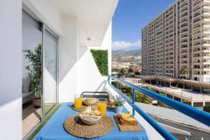 a table with food and drinks on a balcony at Sunny Island Paraiso Sur in Adeje