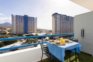 a table on a balcony with a view of buildings at Sunny Island Paraiso Sur in Adeje