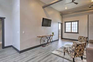 a living room with a table and a chair at Cherokee Vacation Rental - On Main Street! in Cherokee