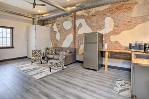 an office with a brick wall with a couch and chairs at Cherokee Vacation Rental - On Main Street! in Cherokee