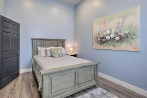 a bedroom with a bed with a painting on the wall at Cherokee Vacation Rental - On Main Street! in Cherokee