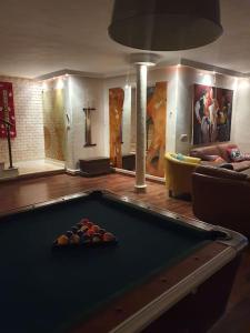 a billiard room with a pool table and a couch at Villa Carthagene /Jacuzzi -swimingpool- Billard in Sidi Daoud