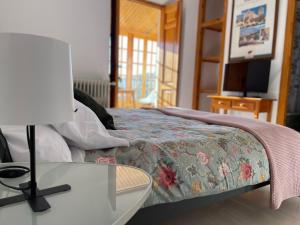 a bedroom with a bed with a table and a television at Hospedium Casa Convento Sierra de María in María