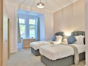a bedroom with two beds and a window at Cur Cottage - Uk7809 in Coirantee
