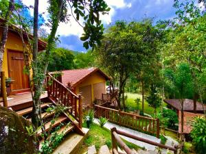 a house with a wooden staircase leading up to it at Espaço Viverde Penedo in Penedo