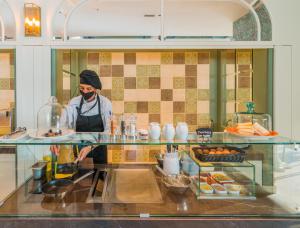 a person standing in a kitchen preparing food at Catalonia Donosti in Donostia-San Sebastián