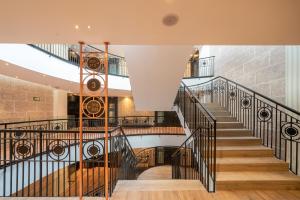 a spiral staircase in a building with wooden floors at Catalonia Donosti in Donostia-San Sebastián