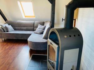a living room with a woodburning stove in front of a couch at Charmante Ferienwohnung mit Kaminofen in Bremerhaven +2 photos