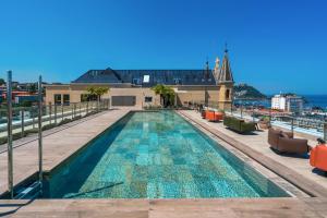 a swimming pool on the roof of a building at Catalonia Donosti in Donostia-San Sebastián