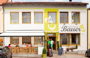 a restaurant with people standing outside of it at Gasthaus Bauer in Grafenschlag