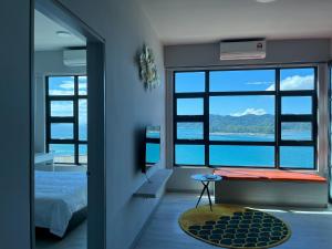 a bedroom with a bed and a view of the water at Jesselton Point Seaview Homestay Kota Kinabalu in Kota Kinabalu
