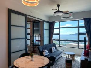 a living room with a couch and a table at Jesselton Point Seaview Homestay Kota Kinabalu in Kota Kinabalu