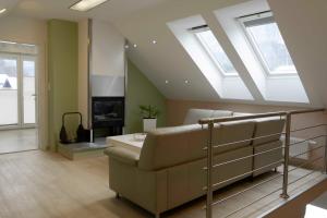 a living room with a couch and skylights at Hiška pod gradom in Celje